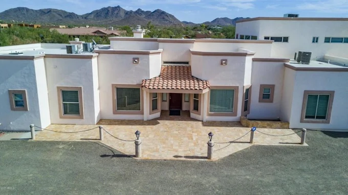 The Desert Hills House — exterior framed by mountains