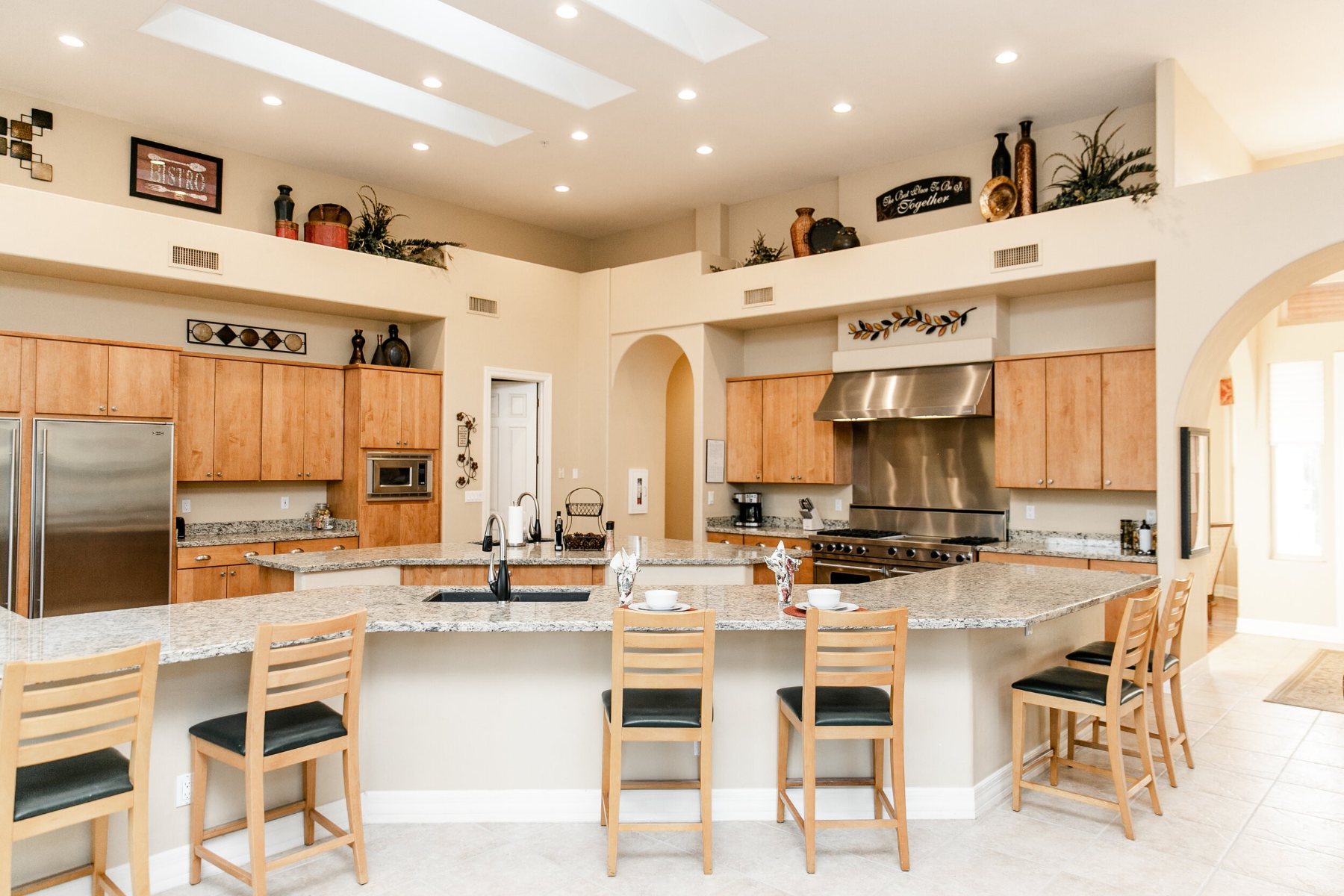Large kitchen with a granite island, bar seating and skylights