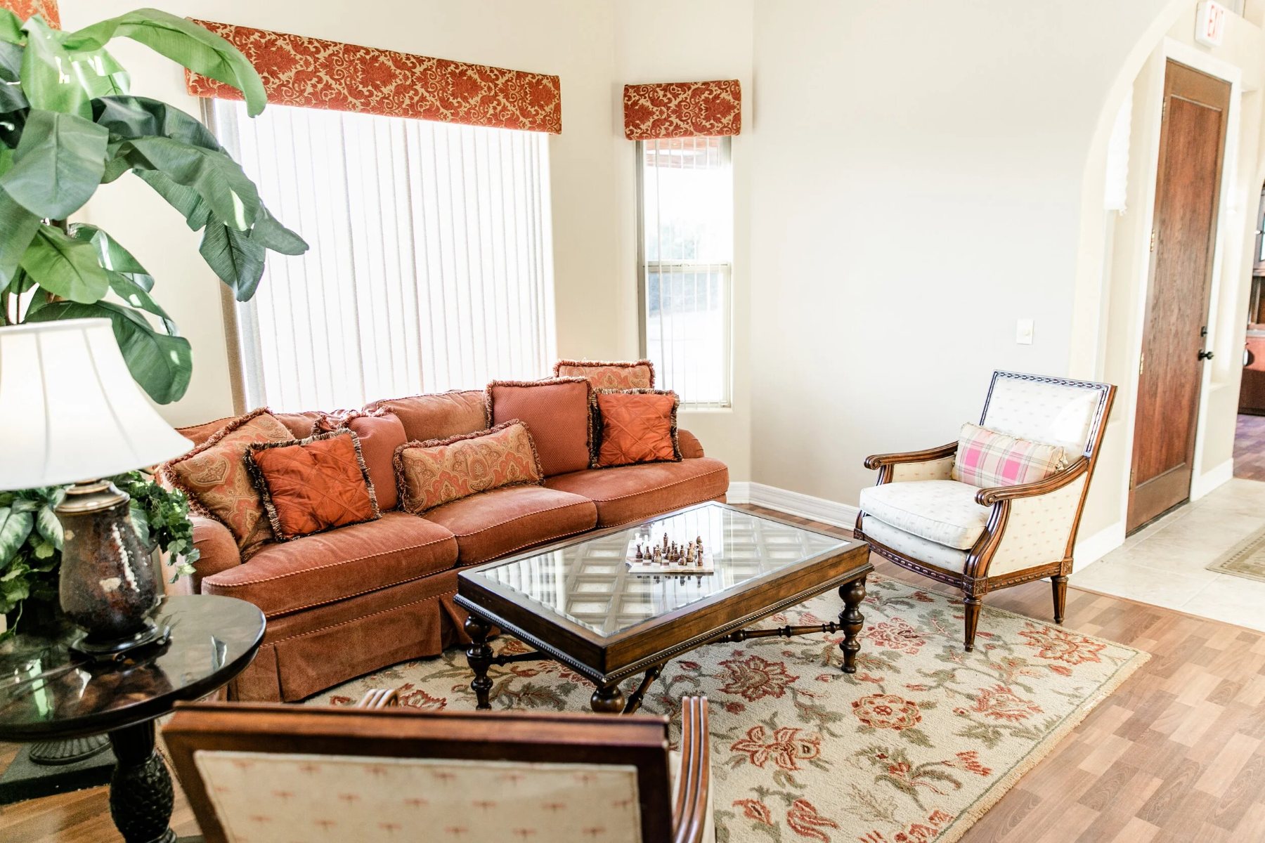 Sitting room with a sofa, armchair and chessboard on the coffee table